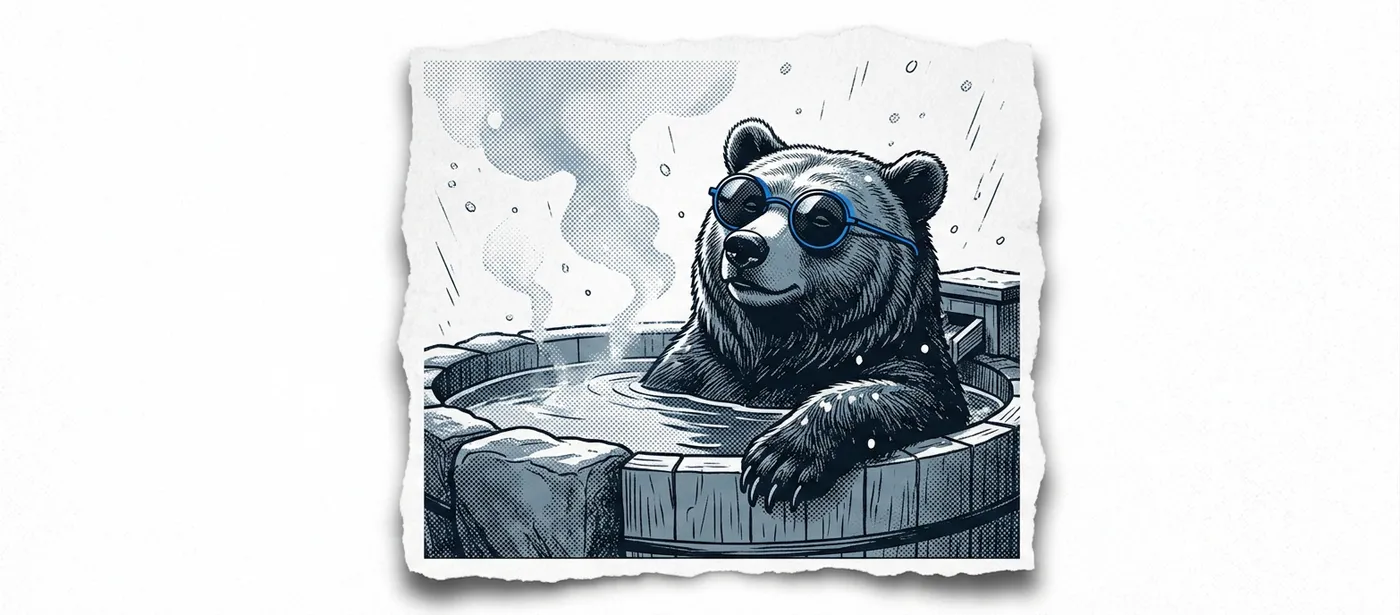 Yuki the bear soaking up to his shoulders in a steaming outdoor onsen as snow falls.
